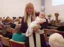 Rev Barbara Ann shows Holly to the congregation